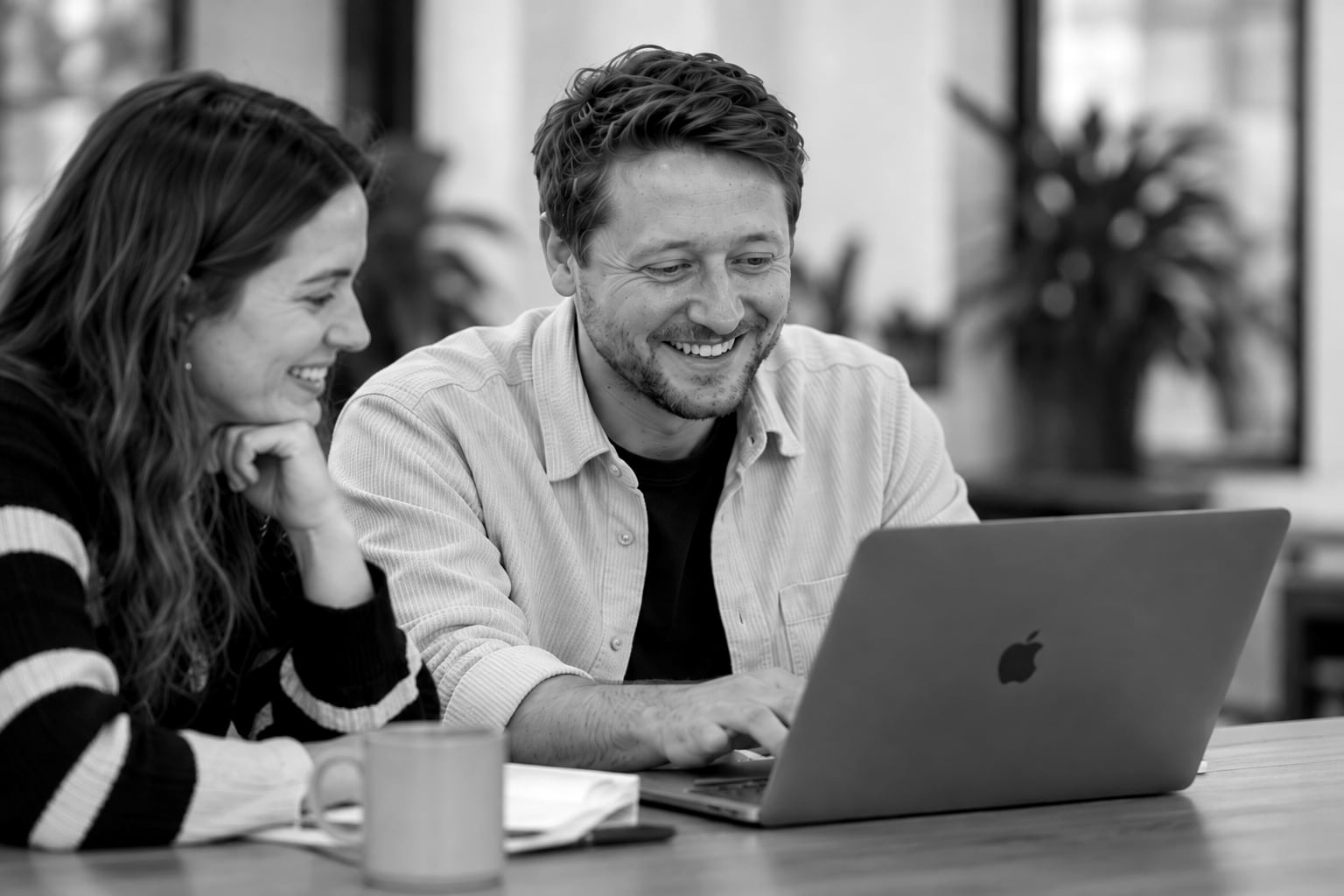 Two people at a laptop in the studio